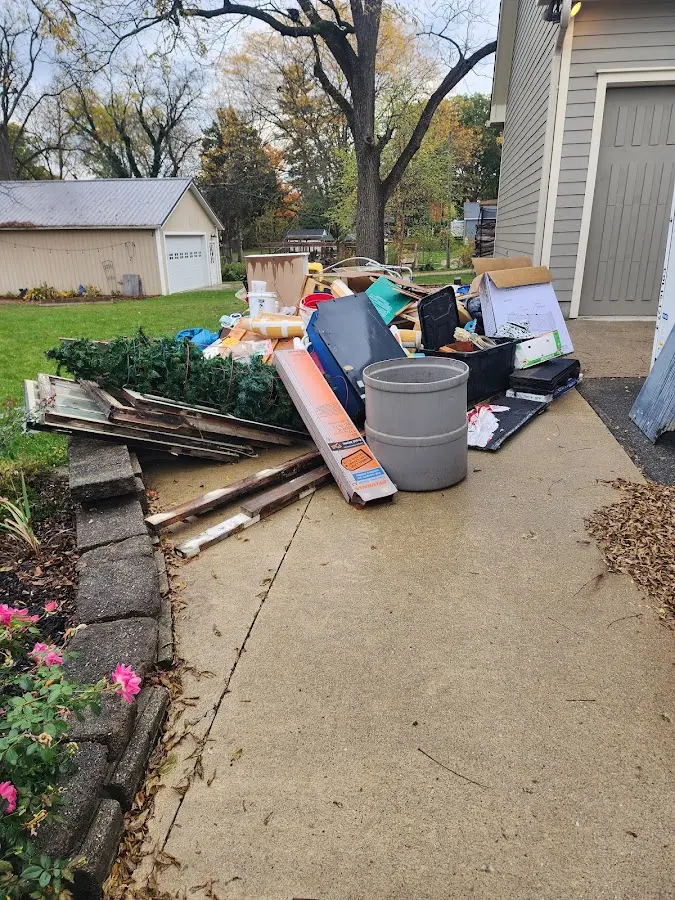 Dumpster being loaded with debris for Estate Cleanout Dumpster Rental in Belle Haven
